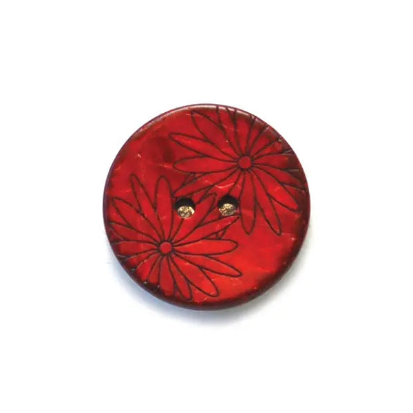 Red button with floral design on a white background